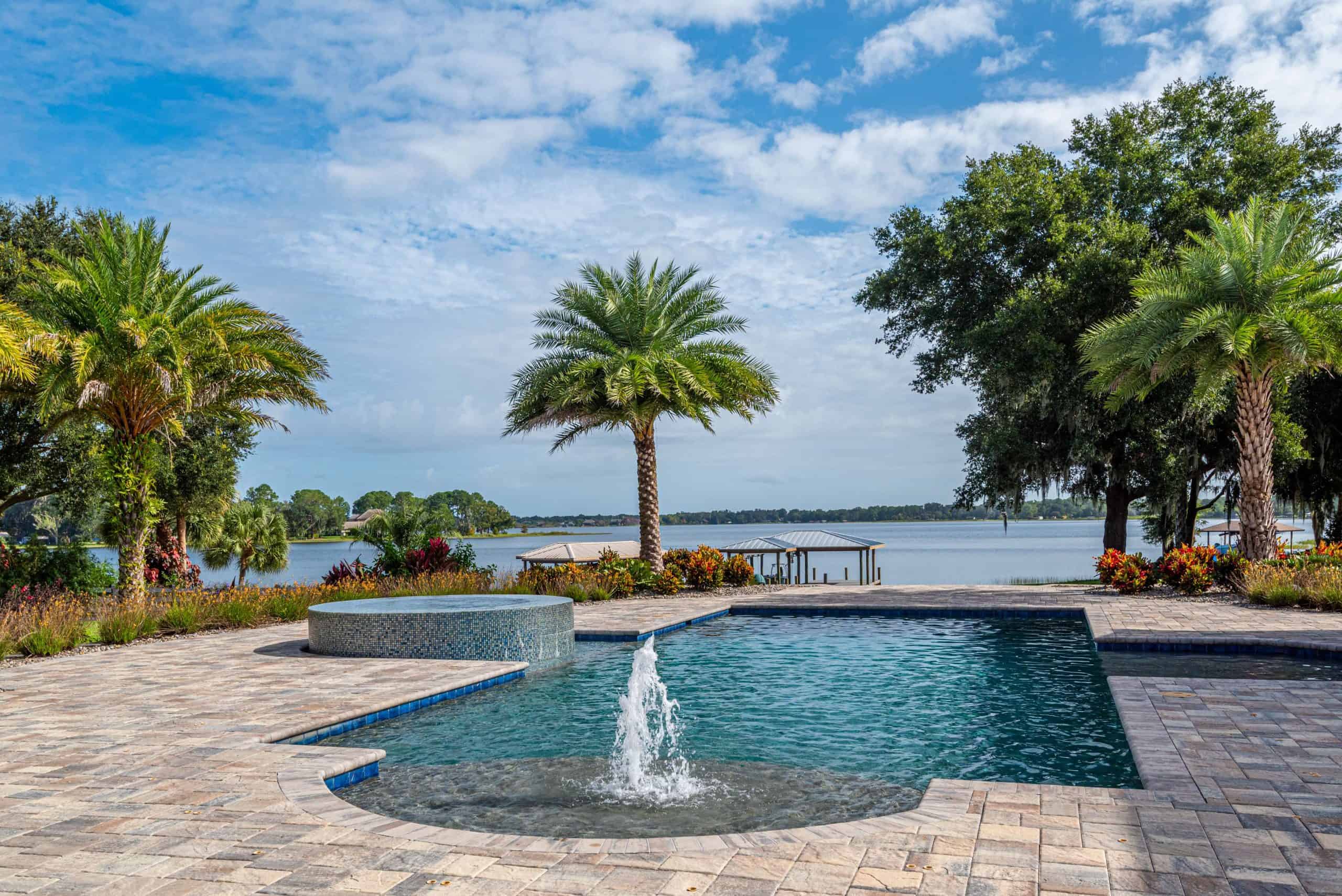 Elegant backyard pool with palm trees and lake views in Cocoa Beach, Brevard County FL