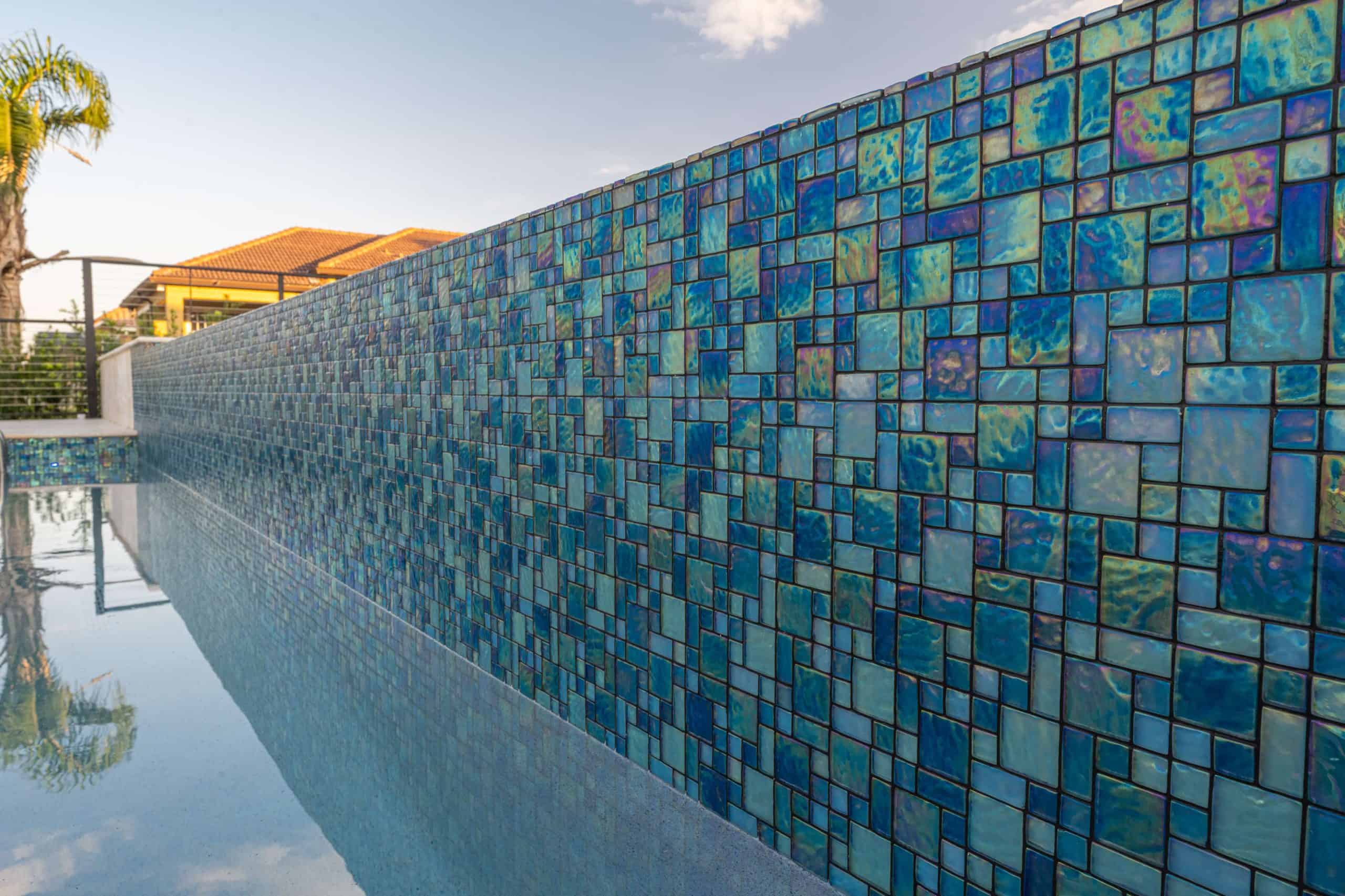 McDonald Photography10 Colorful mosaic tile water feature at a luxury custom-designed swimming pool in sunny outdoor setting.