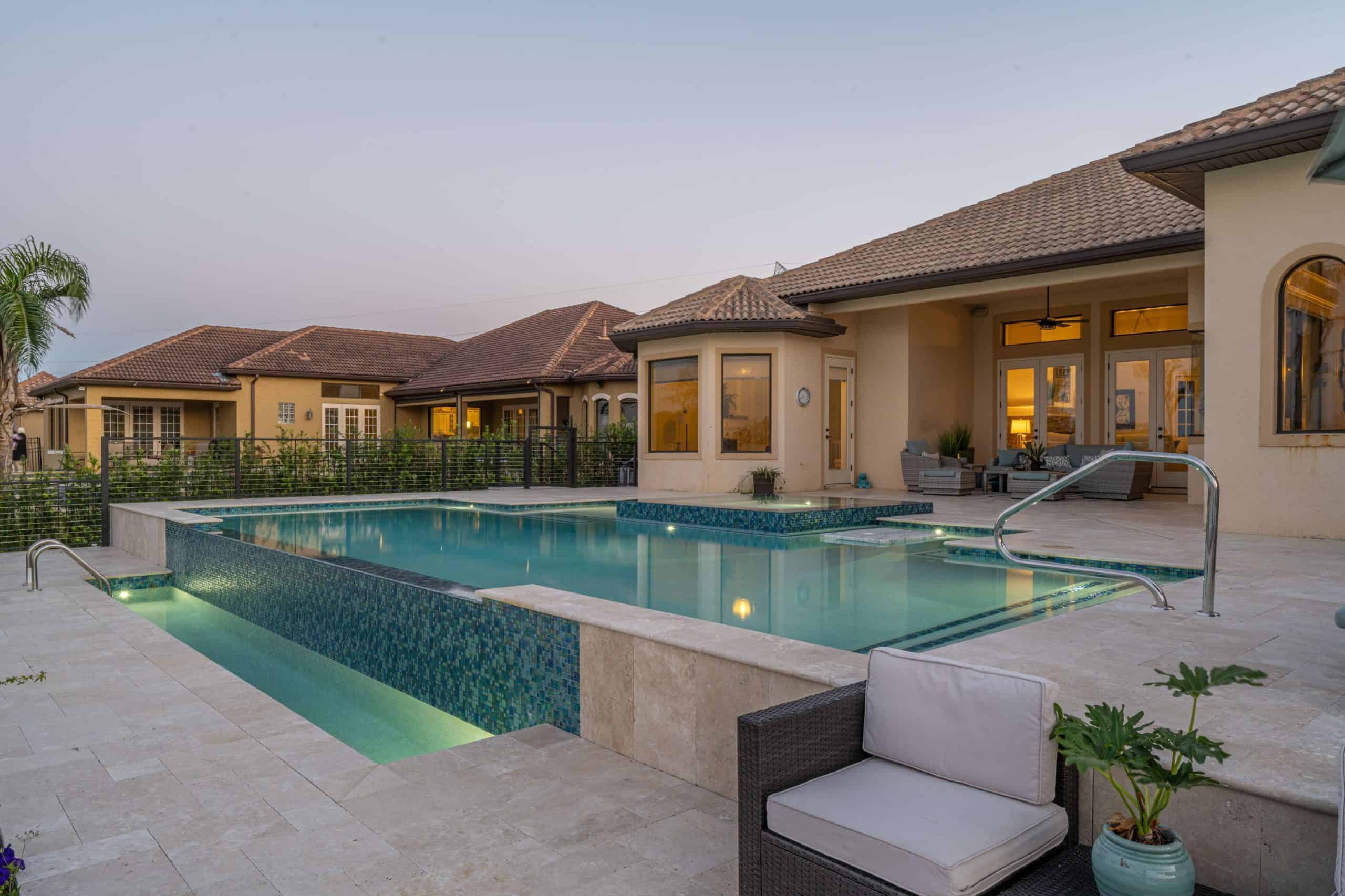 Luxury custom-designed backyard swimming pool with modern features and elegant landscaping in Oceanfront Homes, Cocoa Beach