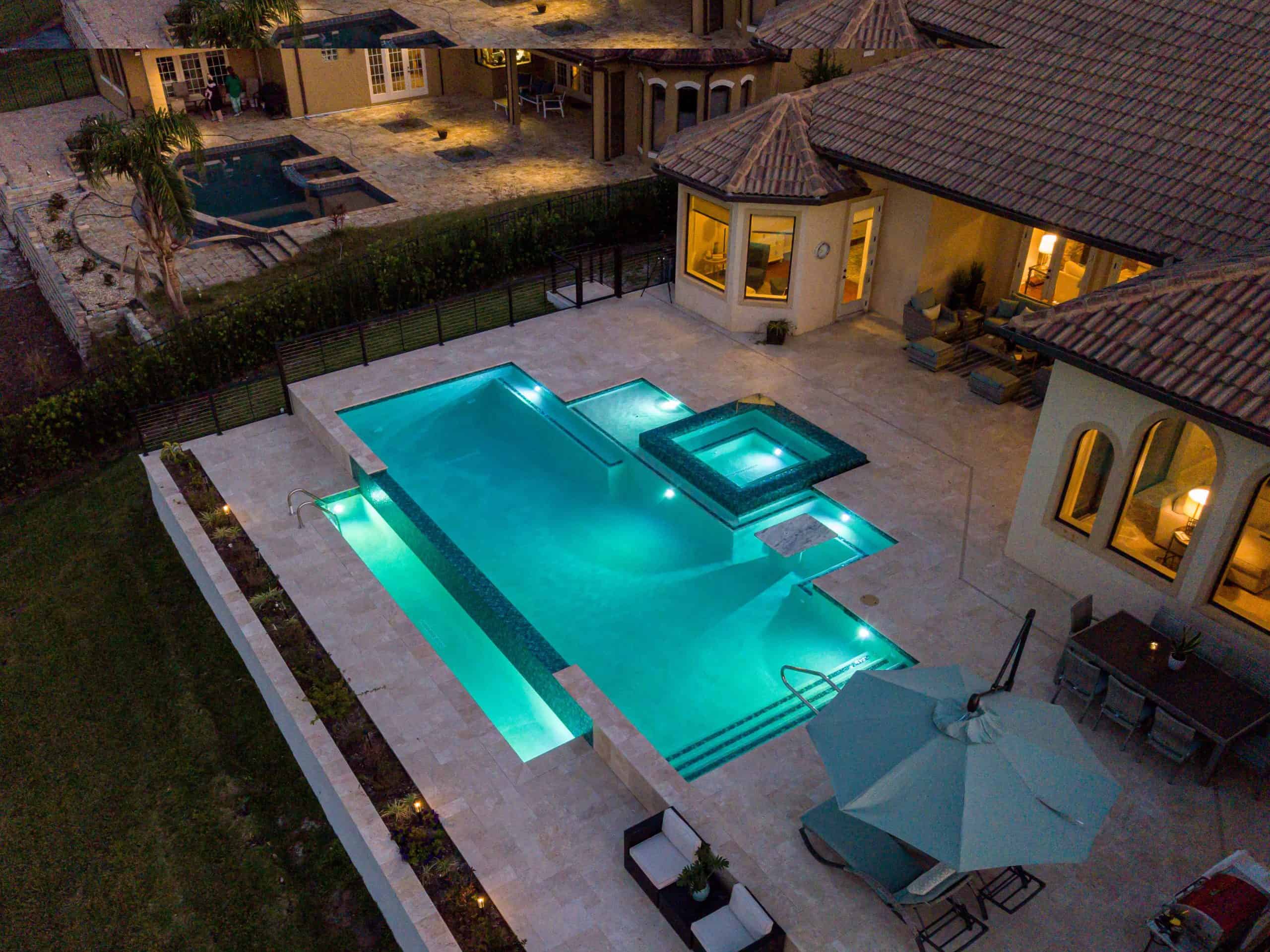 Luxurious backyard pool with hot tub, modern lighting, and outdoor seating at sunset in Kissimmee, Osceola County FL