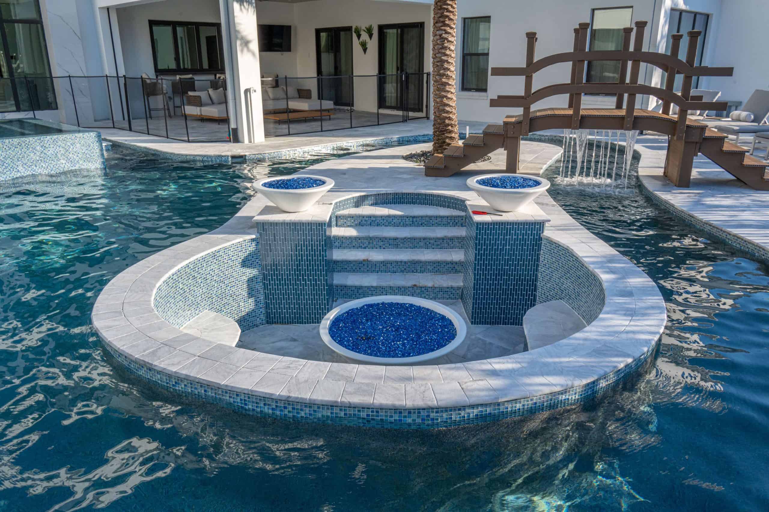 Luxurious illuminated backyard swimming pool under a screened porch with a scenic lake view at dusk in Ponte Vedra Boulevard Oceanfront
