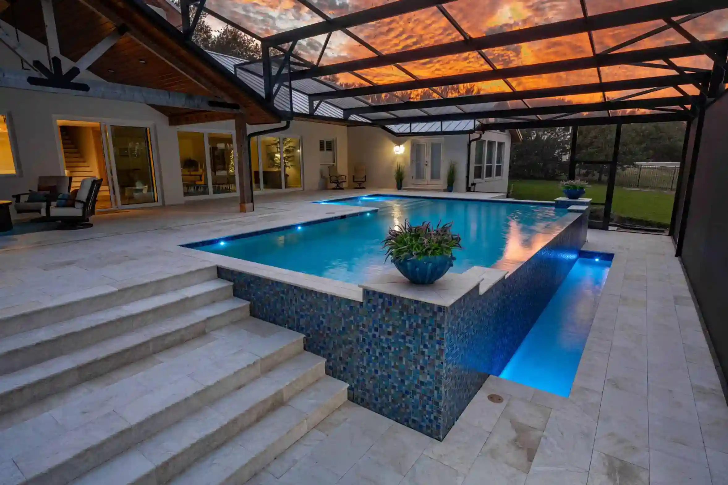 DSC_2055-Edit-scaled_11zon Aerial view of a custom-designed luxurious pool with lounge chairs, palm trees, and a spa area.