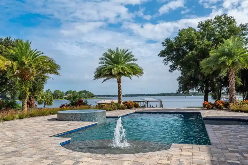 Custom infinity edge pool with lush landscaping and water features in Florida